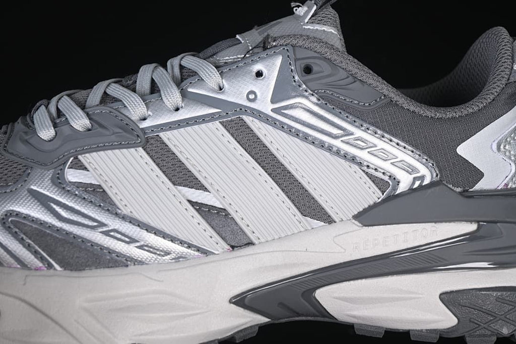Close-up of the layered silver and gray side panels and sculpted midsole.