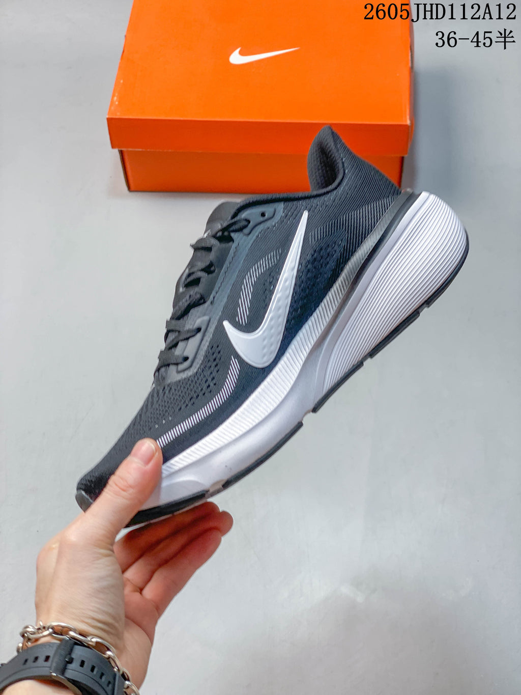 Side profile of a dark gray Nike Air Zoom Pegasus 42 with white swoosh and midsole