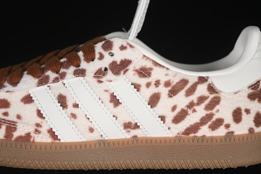 Close-up of white side stripes, spotted upper, and brown laces