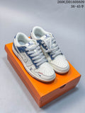 Pair of cream and blue denim-print low-top sneakers displayed on an orange shoe box