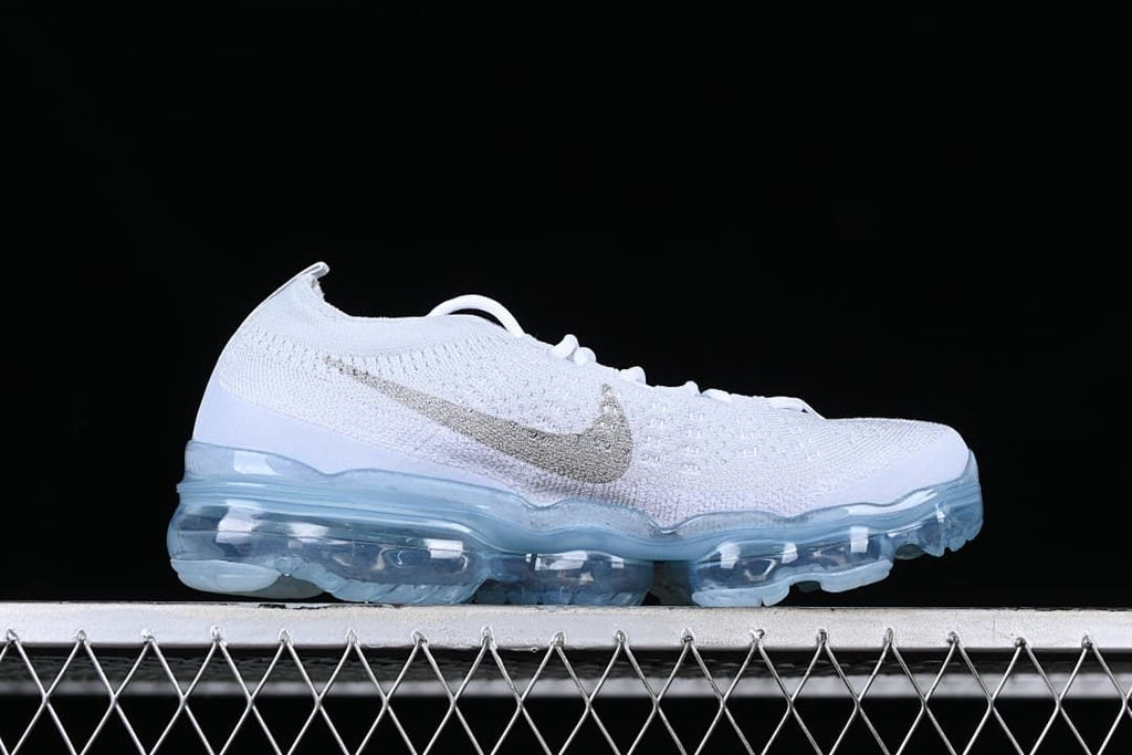 Side profile of the white knit sneaker with translucent blue sole