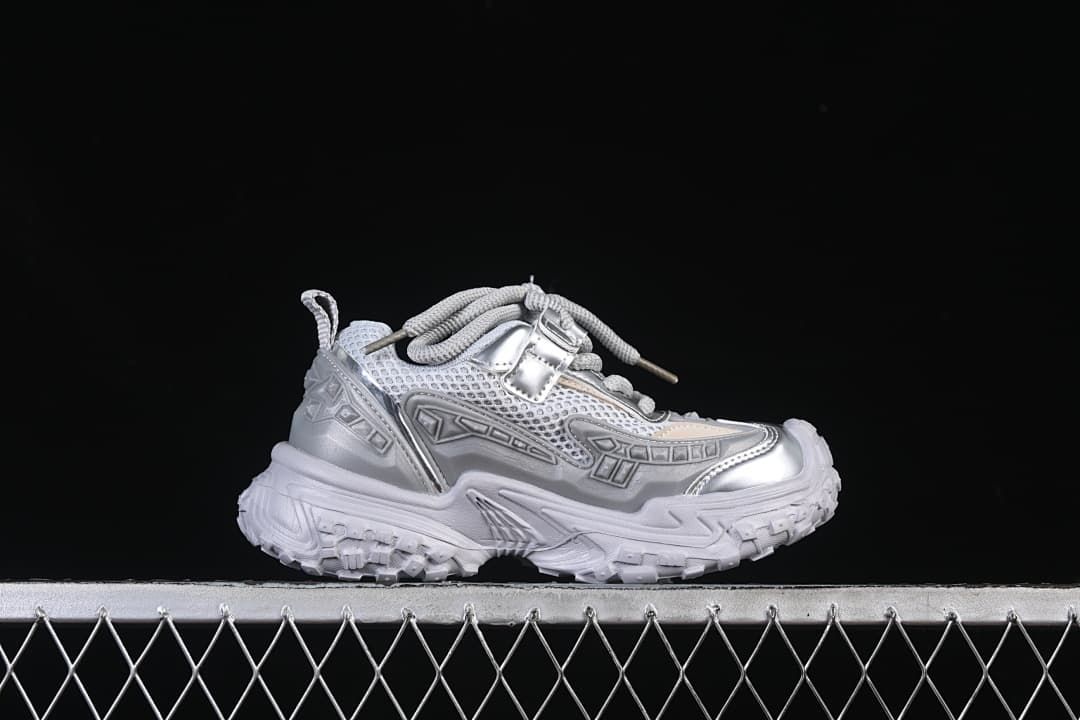 Side profile of a silver and light gray chunky sneaker