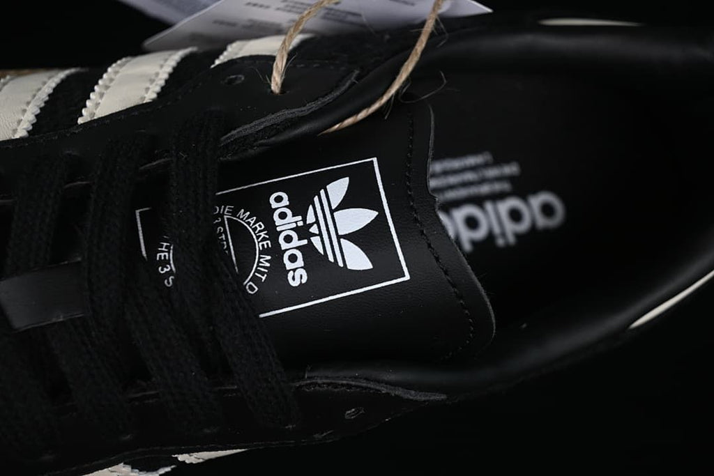 Close-up of the adidas tongue label and black laces