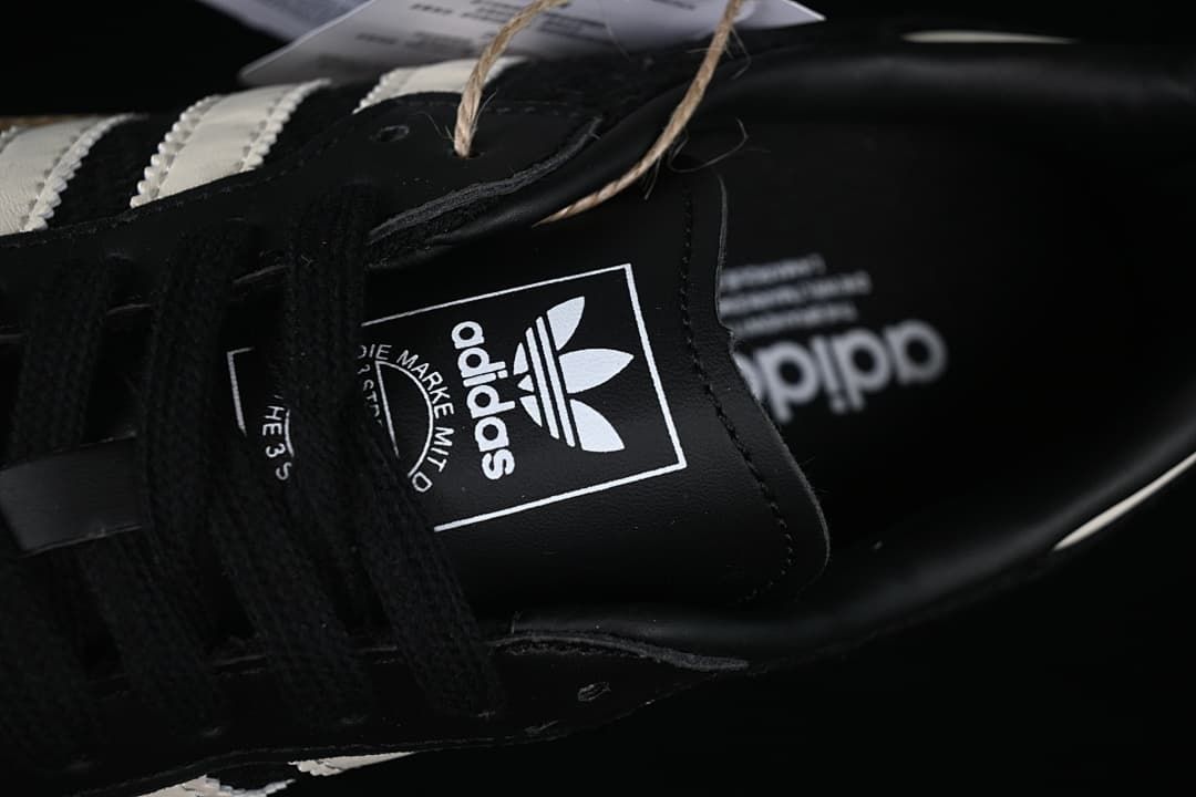 Close-up of the adidas tongue label and black laces