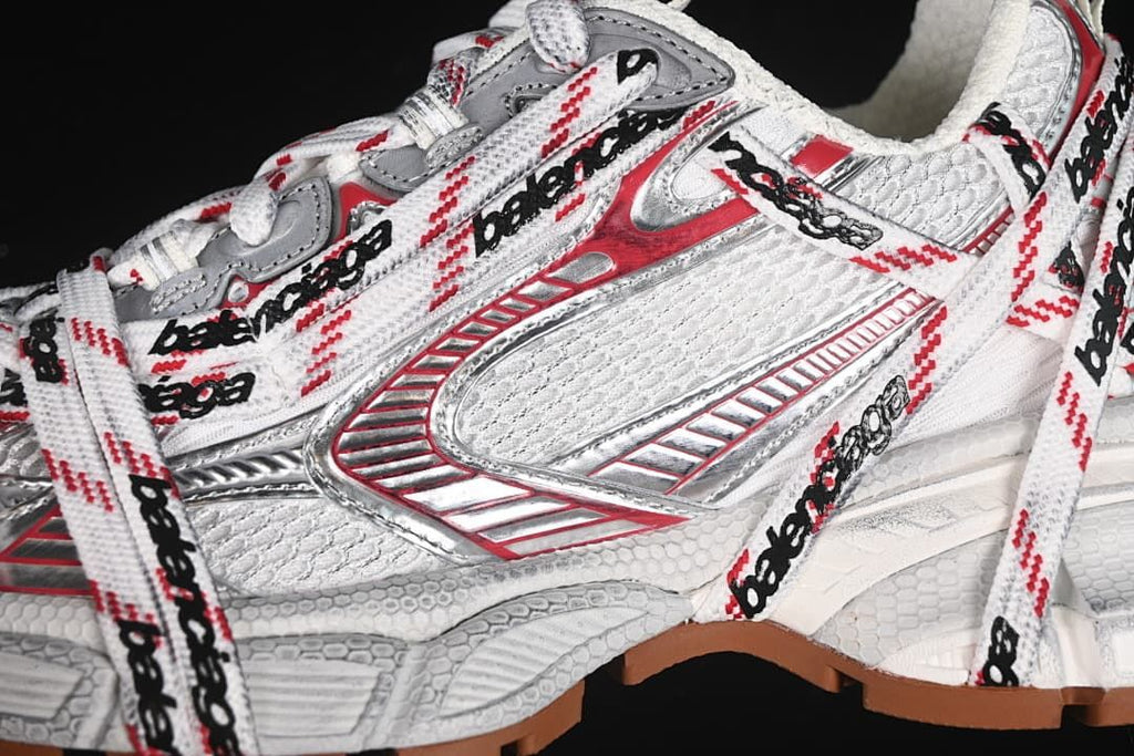 Close-up of the side panels, metallic-looking accents, and logo-patterned laces
