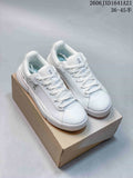 Pair of white On The Roger low-top sneakers displayed on a shoebox