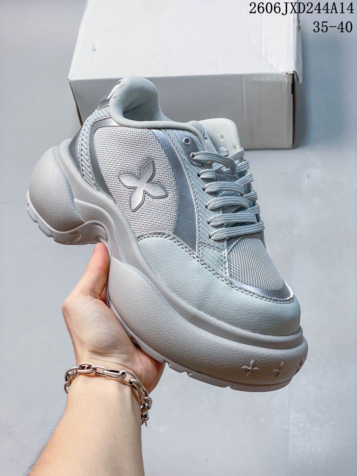 Side view highlighting the flower-shaped emblem, layered upper, and chunky sole