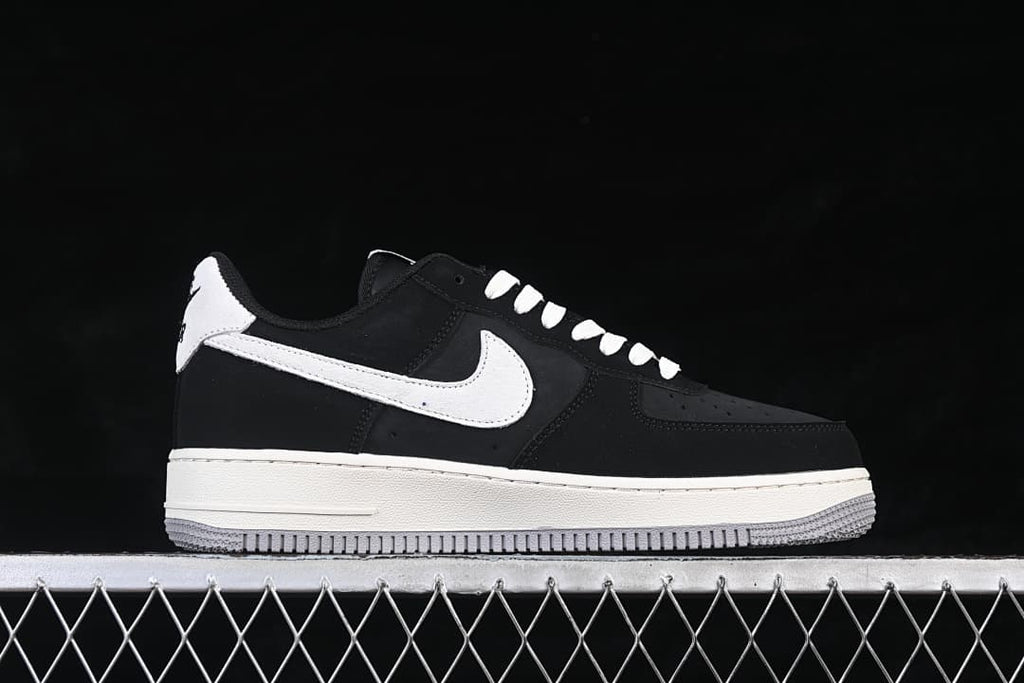 Side view of a black Nike Air Force 1 '07 Low with white Swoosh and gray outsole