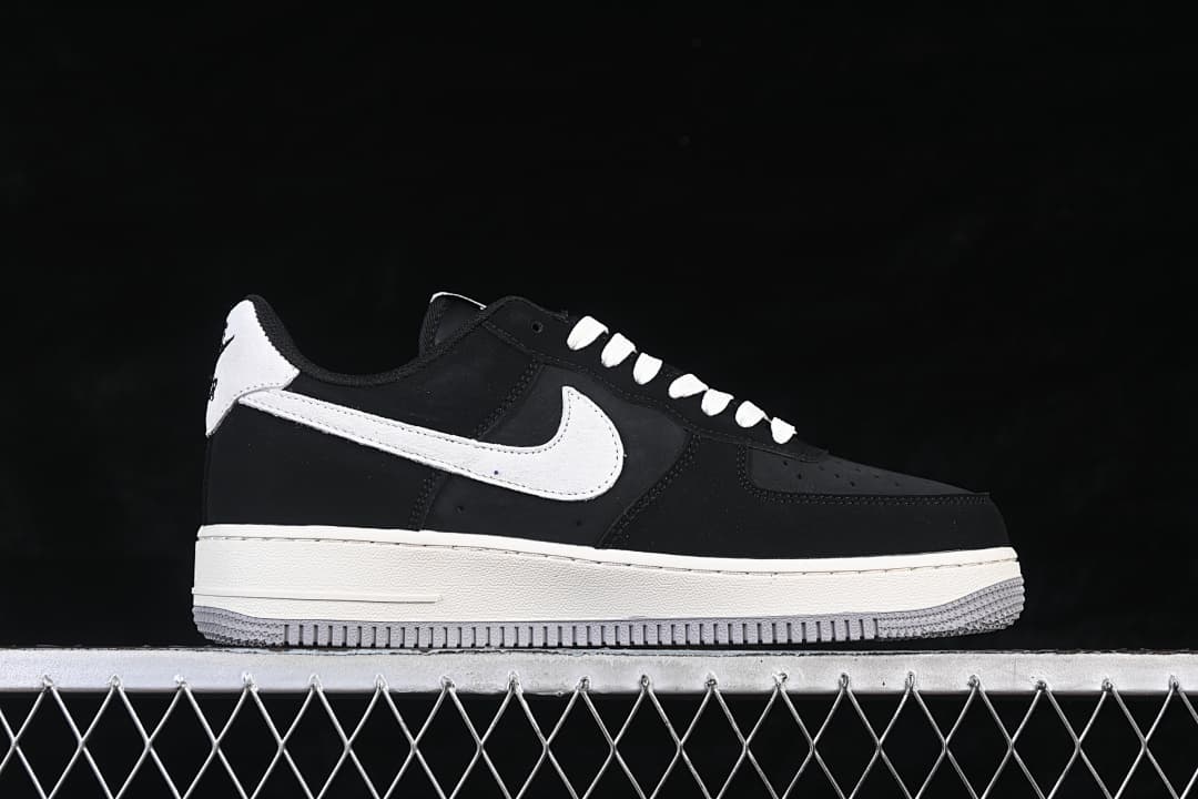Side view of a black Nike Air Force 1 '07 Low with white Swoosh and gray outsole