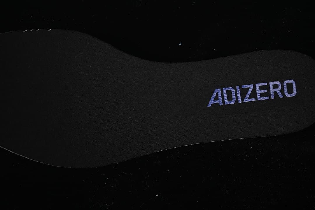 Close-up of an Adizero-branded black shoe insole.