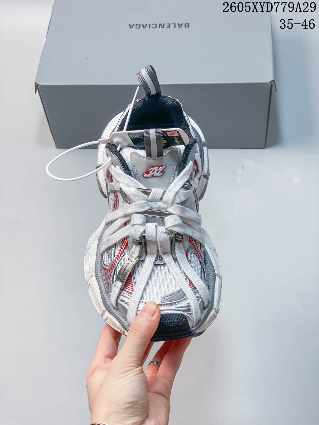 Front view of a Balenciaga Phantom sneaker with white laces and silver and red accents.