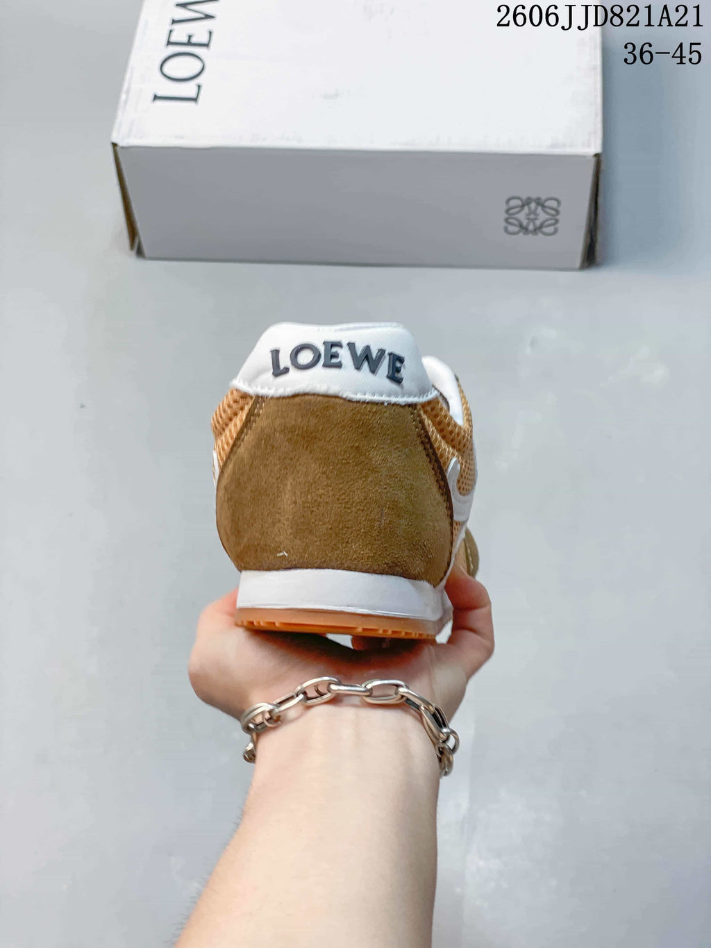 Rear view of the brown sneaker with a branded heel tab