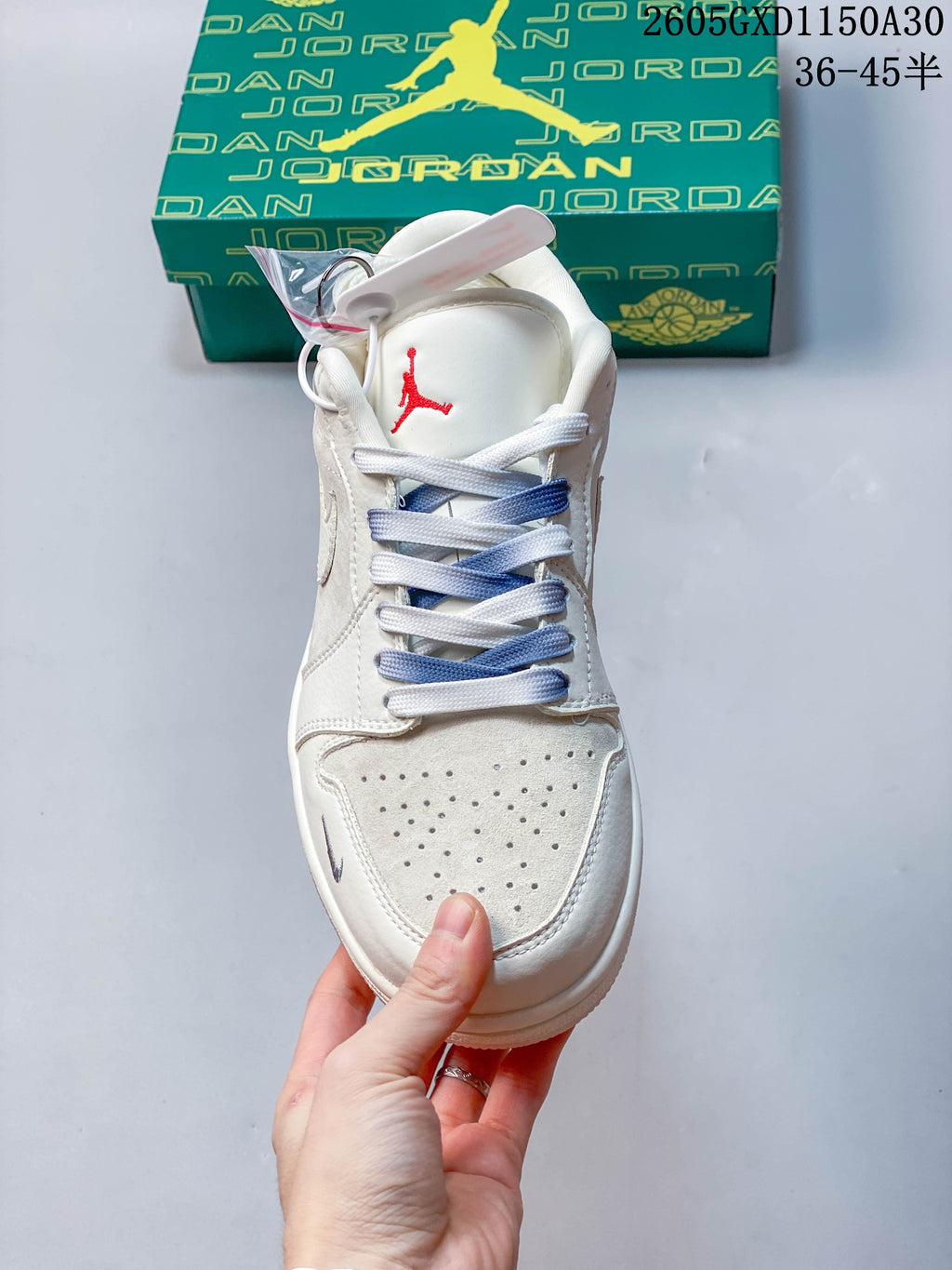 Front view showing perforated toe panels, red tongue accents, and blue-and-white laces.