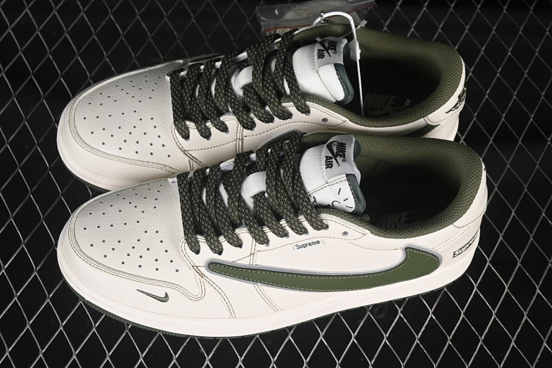 Overhead view of a pair of white Nike low-top sneakers with dark green accents and laces