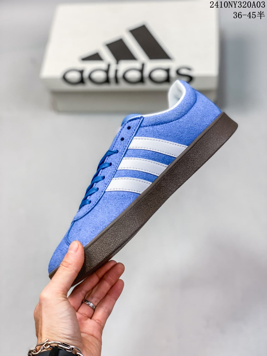 Side view of the blue sneaker with white stripes and dark brown outsole