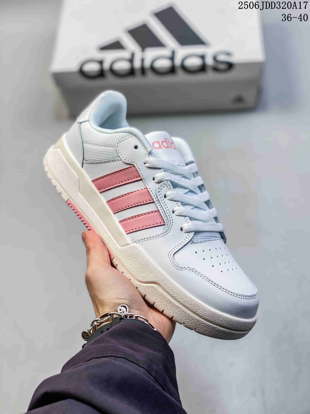 Angled side view of the white adidas Entrap sneaker with pink stripes