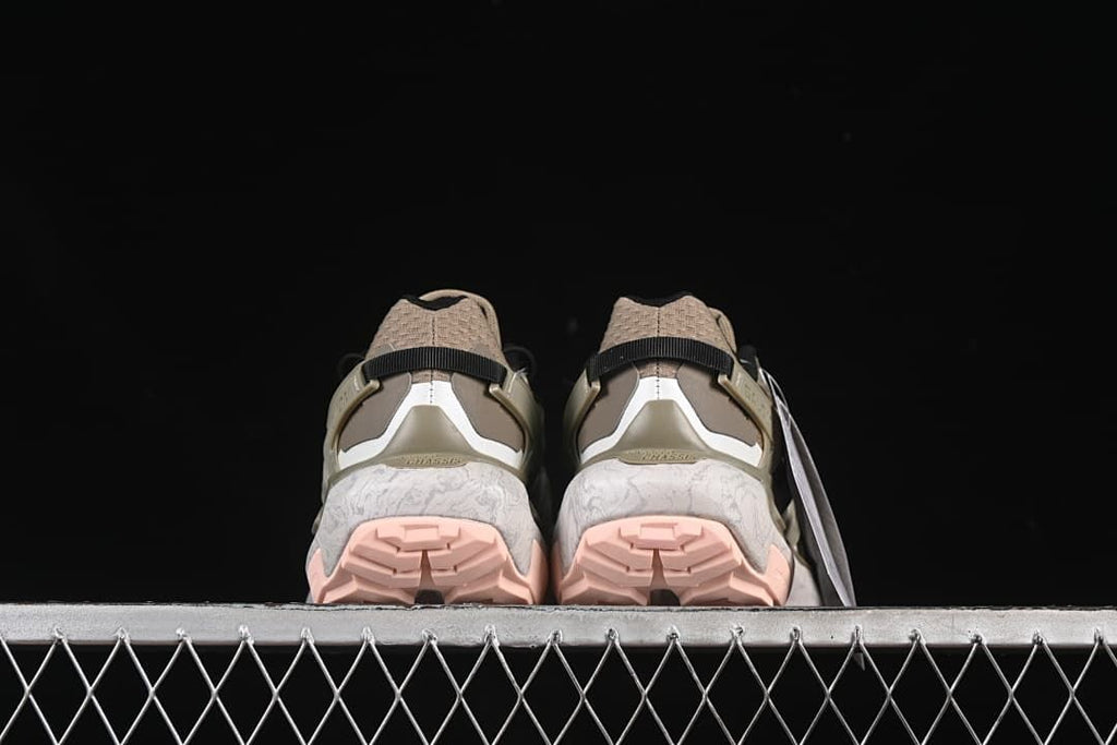 Rear view of both shoes showing heel details and pink outsole sections