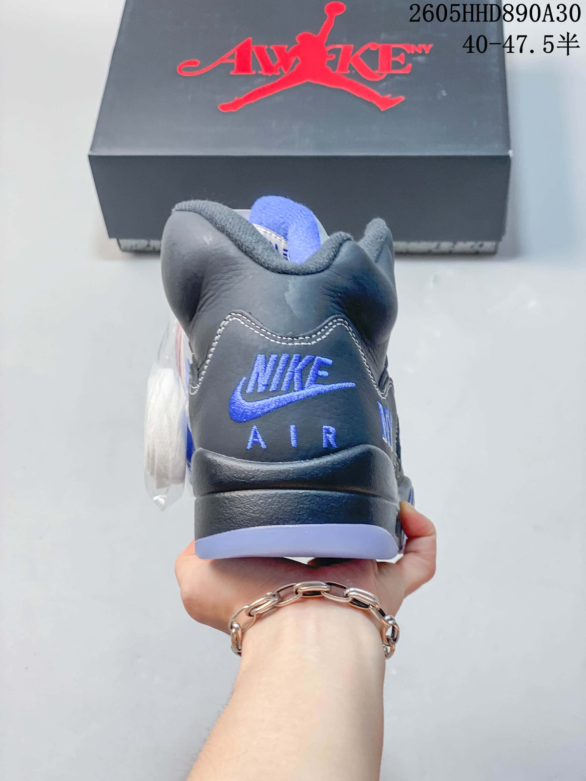 Rear view of an Air Jordan 5 sneaker showing blue heel branding