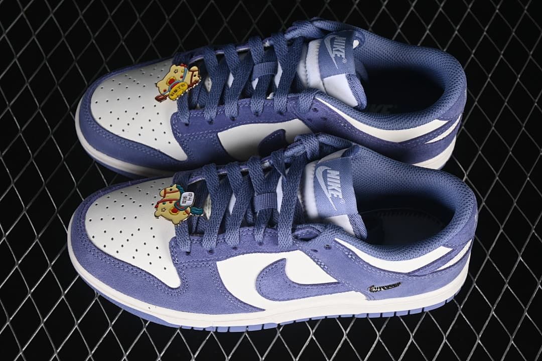 Pair of blue and white low-top sneakers with decorative lace accessories