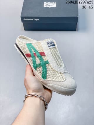Three-quarter view of the cream Onitsuka Tiger Mexico 66 Sabot sneaker with green, red, and navy accents.
