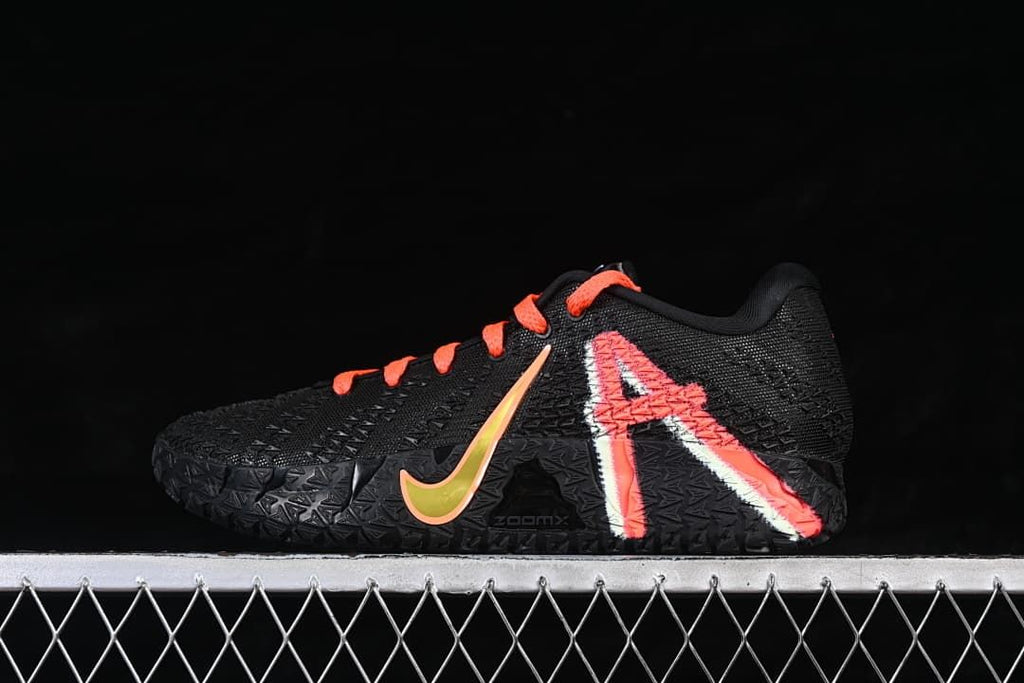 Side view of the black shoe with orange-red graphic accents and bright side swoosh.
