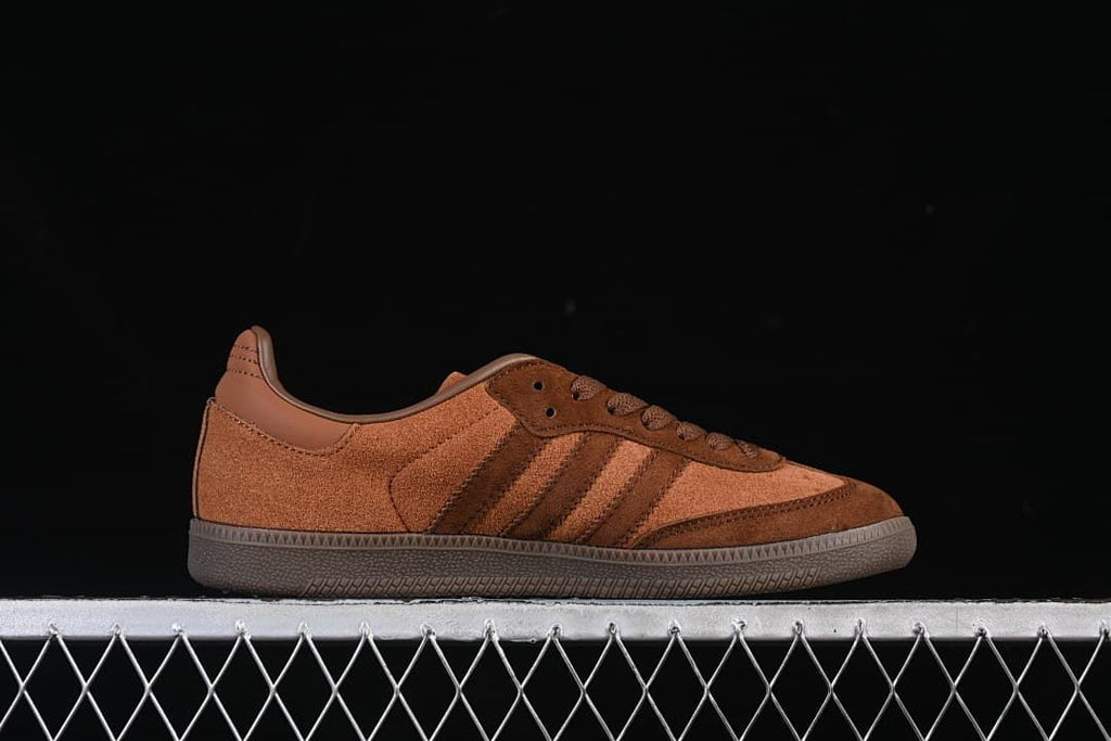 Side profile of a brown Samba sneaker with three stripes and a gum-colored sole