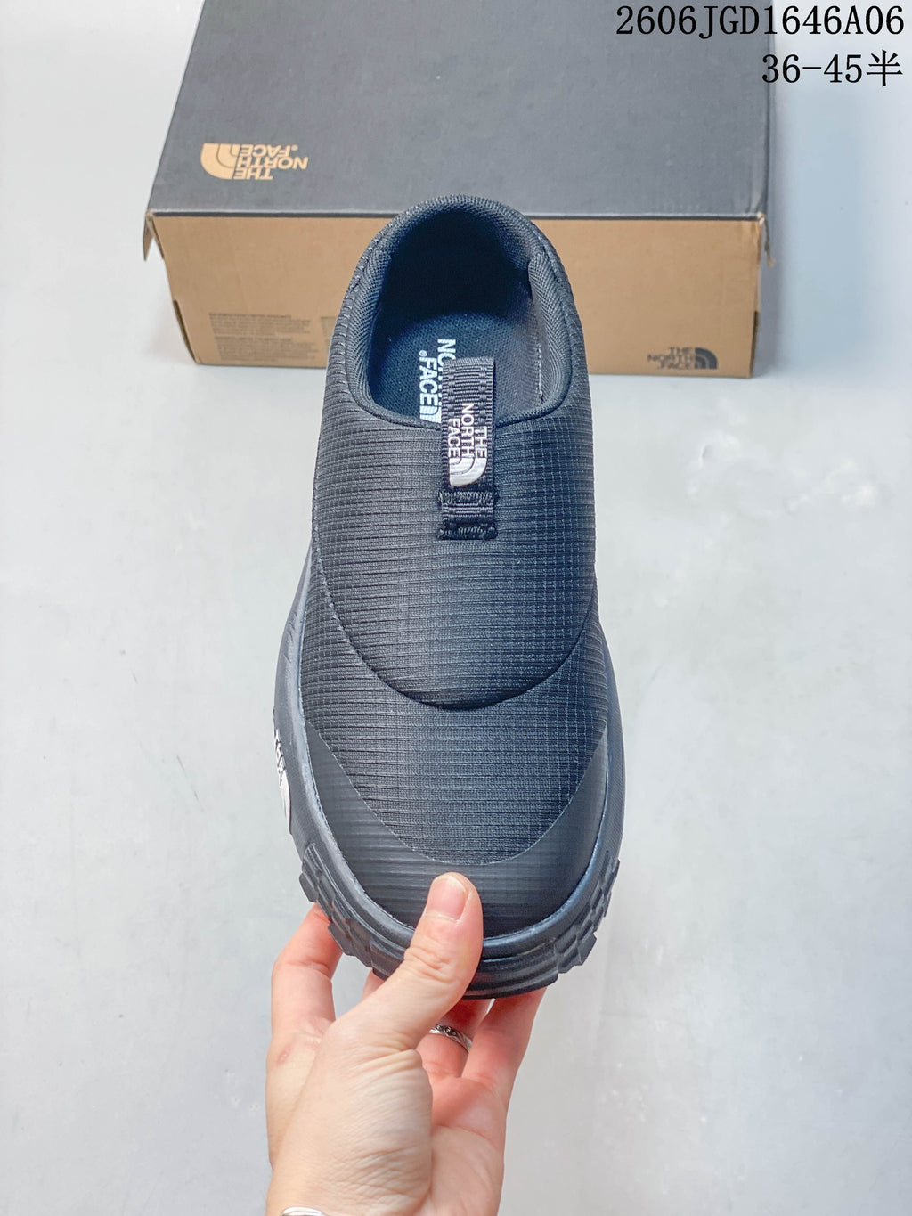 Top view of a charcoal slip-on mule with a pull tab