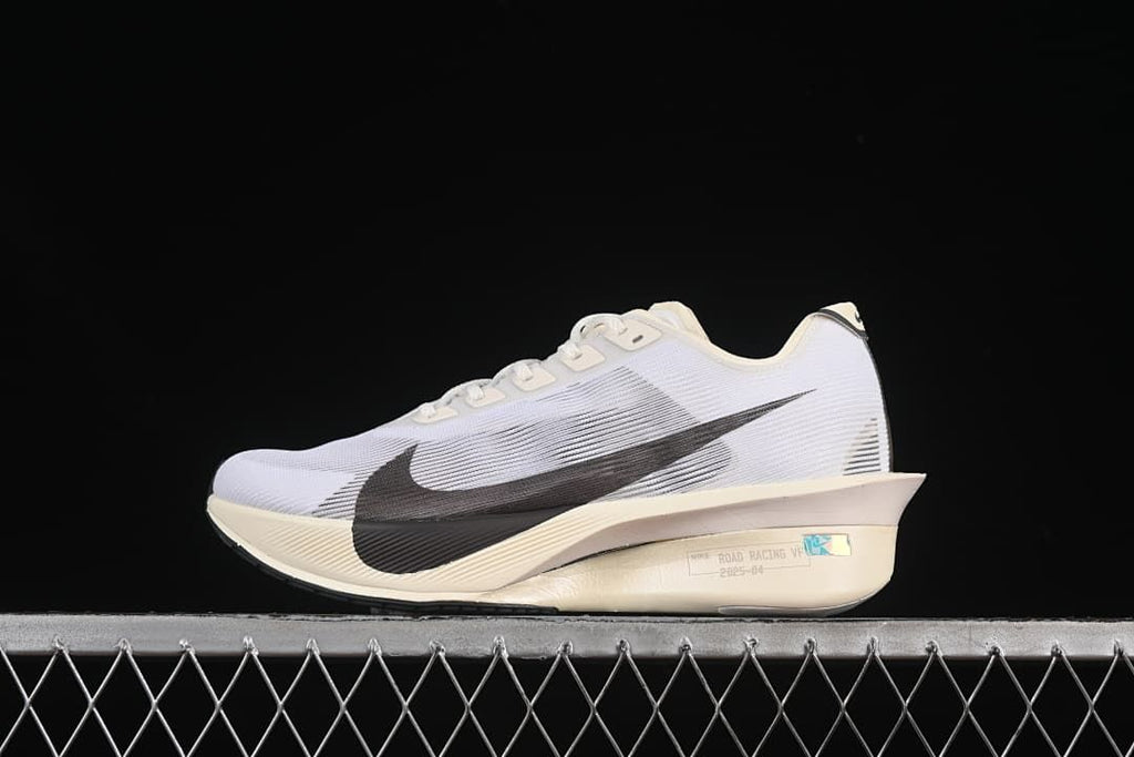 Side view of a white Nike ZoomX Vaporfly NEXT% 4 with dark Swoosh and light cream midsole