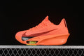 Side view of a bright orange Nike Alphafly running shoe with a dark Swoosh