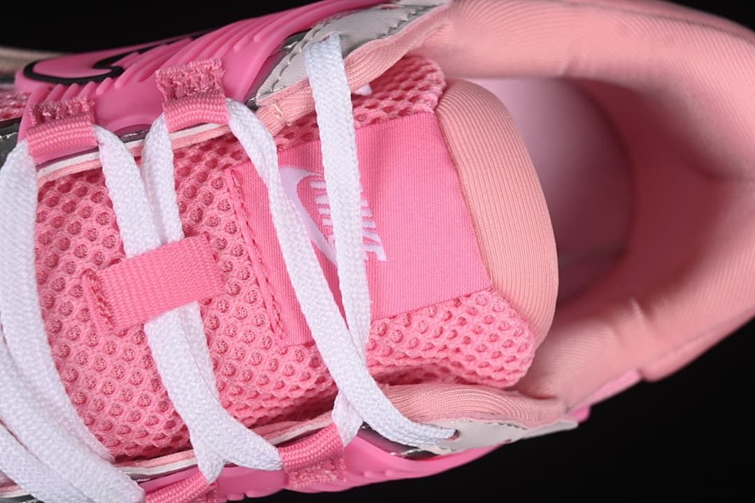 Top close-up of white laces, pink tongue, and padded collar