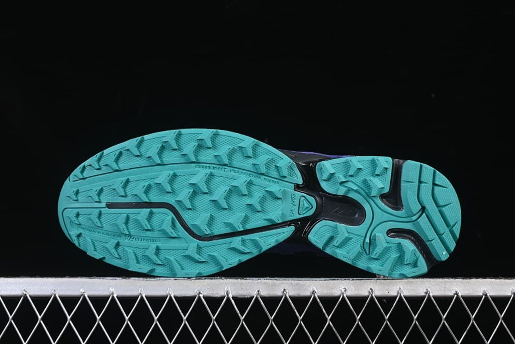 Underside view showing the turquoise tread pattern.
