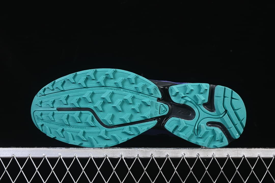 Underside view showing the turquoise tread pattern.