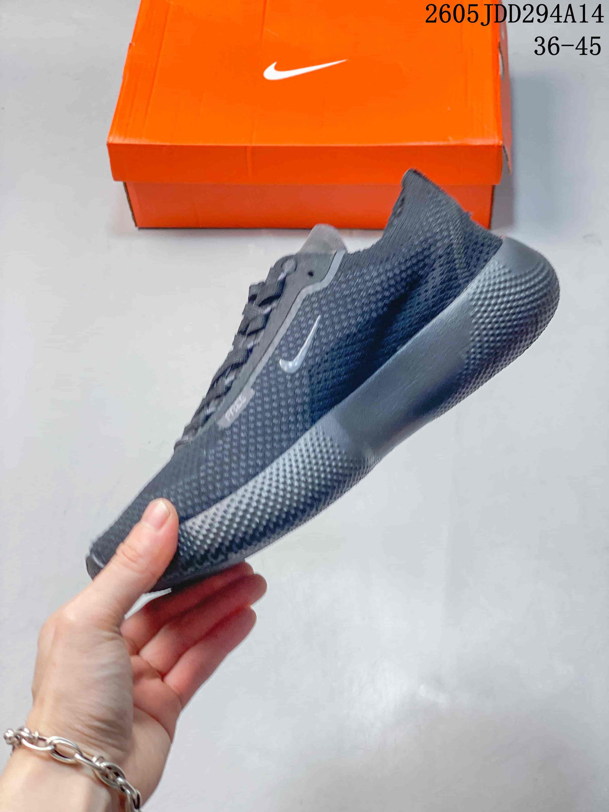 Side profile of the dark gray Nike Free shoe with a textured upper and grooved sole