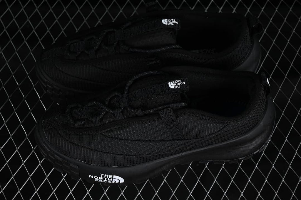 Pair of black low-top shoes shown from above and the side