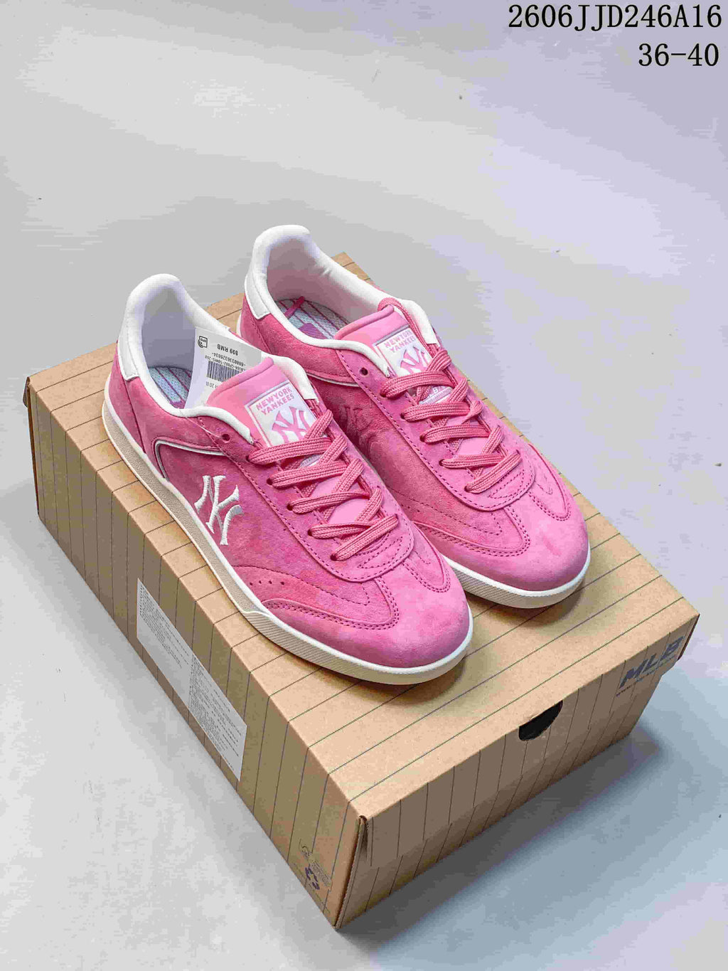 Pink New York Yankees low-top sneakers with white accents, shown as a pair.
