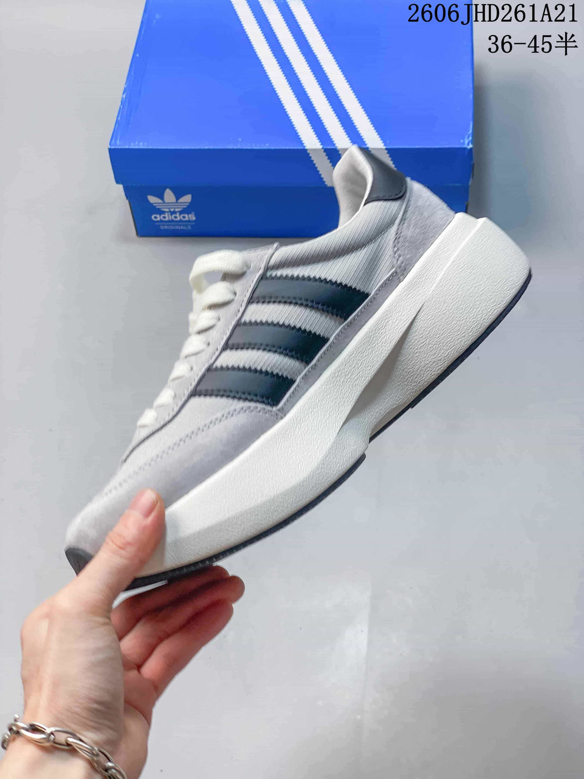 Side view of a grey adidas Originals SL 72 Pro sneaker with dark stripes and a thick off-white midsole