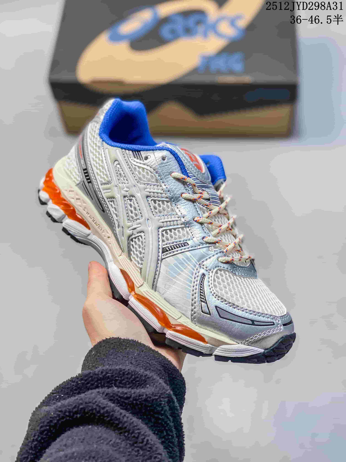 Close view of a silver and white layered running sneaker with blue and orange accents.