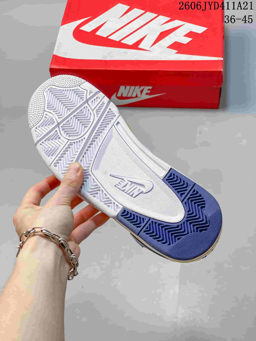 Underside of the sneaker showing a patterned white and blue outsole