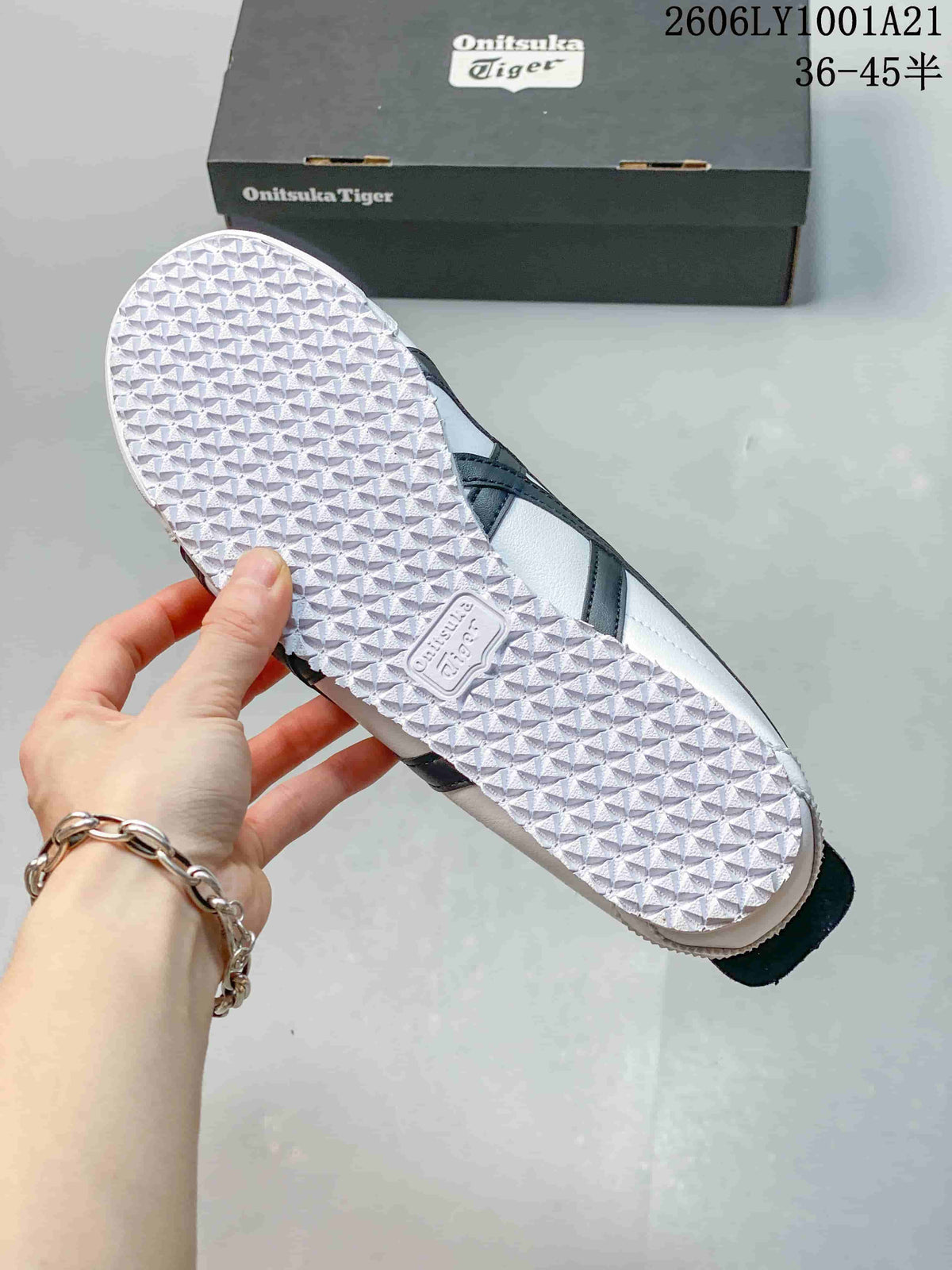 Textured outsole of a white Onitsuka Tiger sneaker with navy side stripes