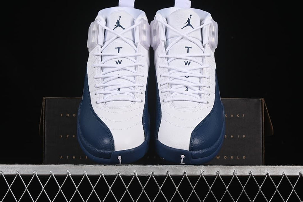 Front view of the pair showing white uppers and navy toe overlays