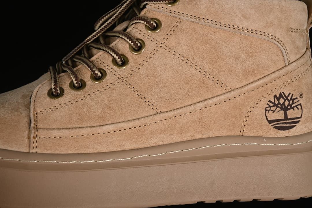 Close-up of side panels, metal eyelets, laces, and Timberland tree logo
