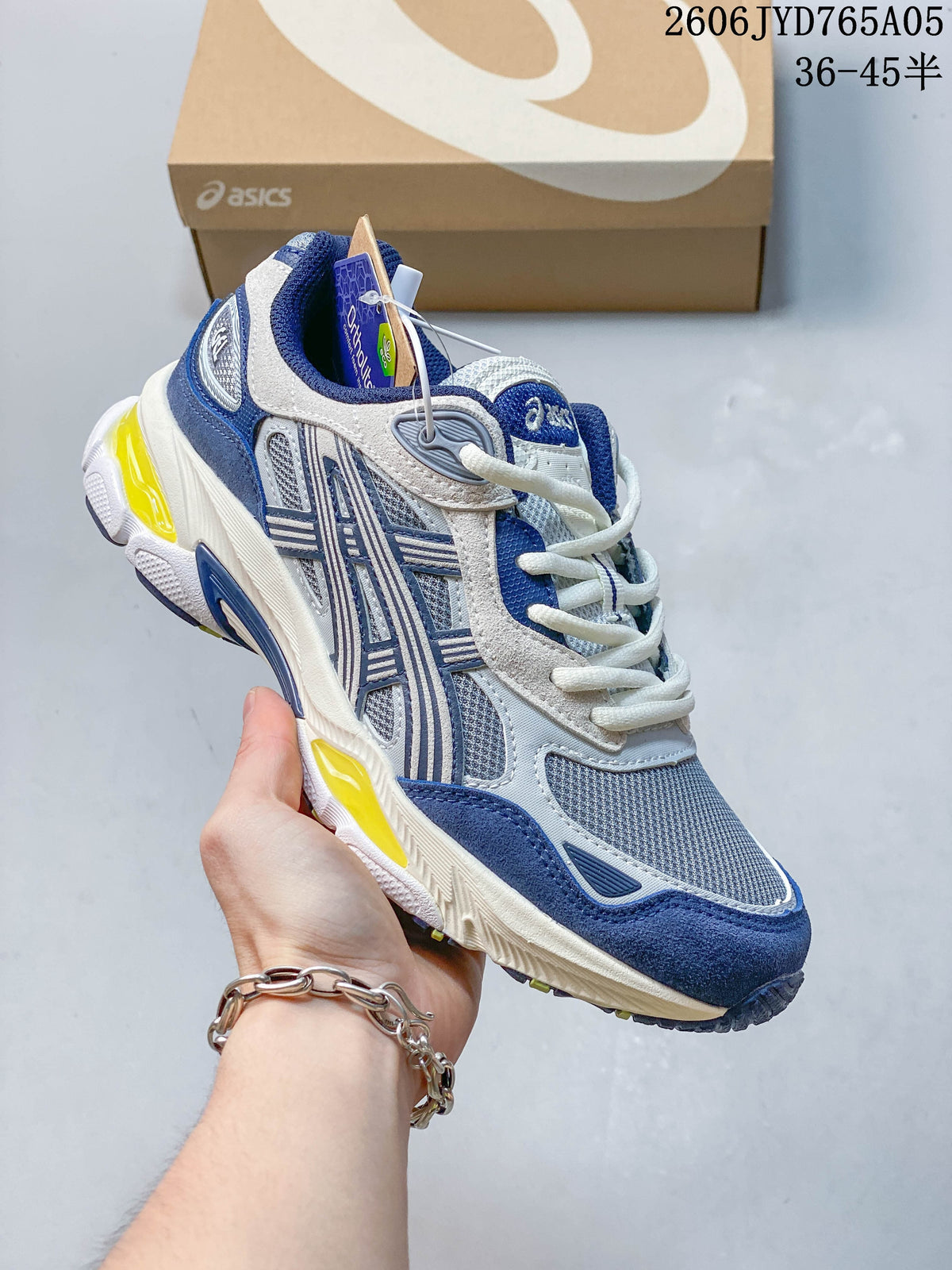 Angled view of the blue and white sneaker with yellow accents and a sculpted sole.