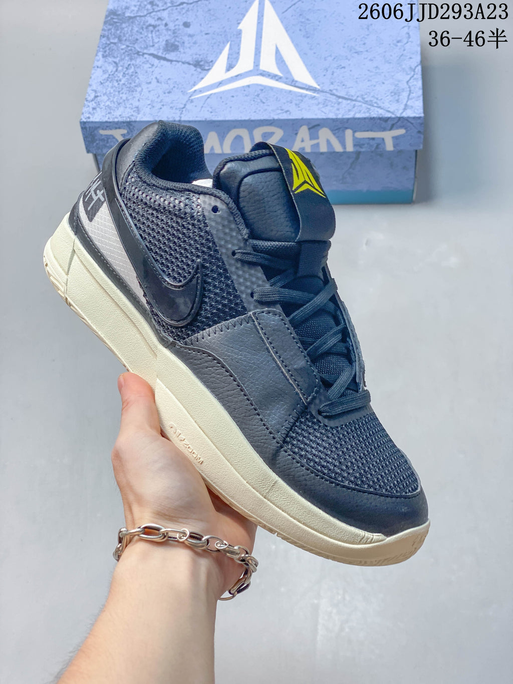 Navy and gray Nike Ja 1 EP shoe with yellow accents.
