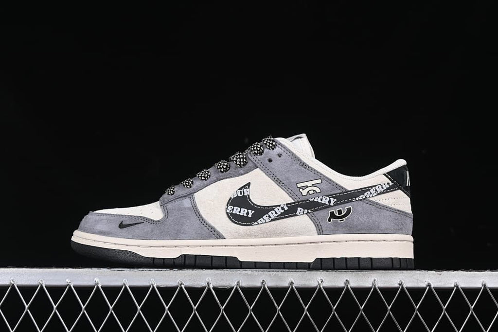 Side view of gray and cream low-top sneakers with a printed black Swoosh and patterned laces