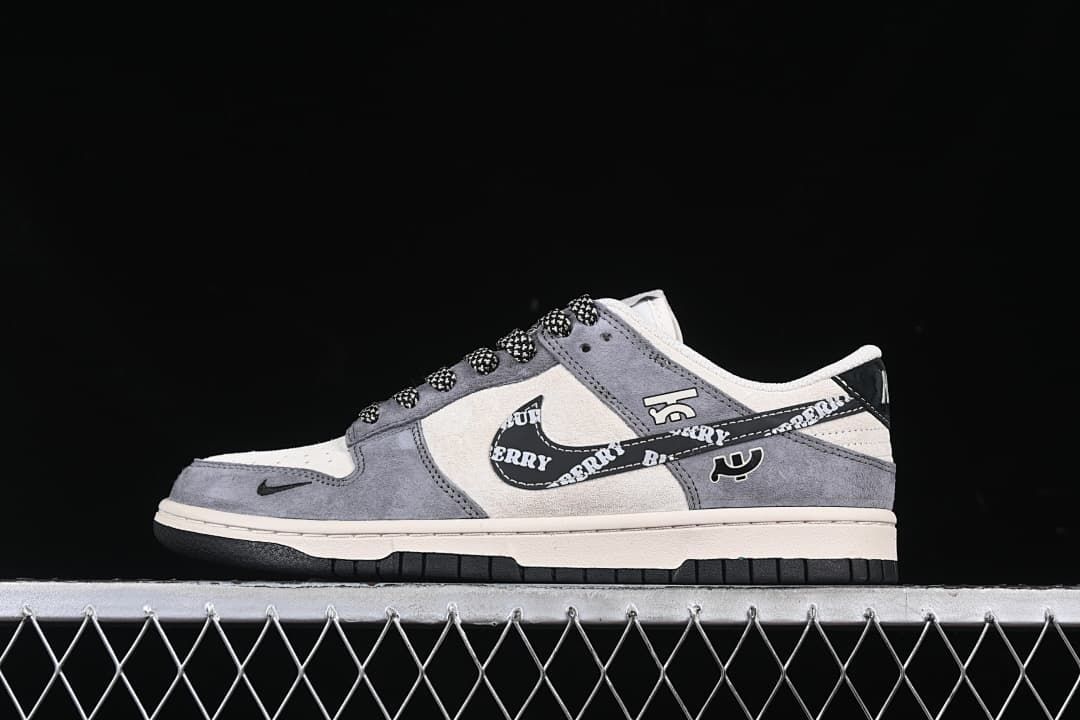 Side view of gray and cream low-top sneakers with a printed black Swoosh and patterned laces