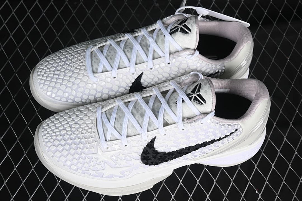 Pair of white low-top basketball shoes shown from above