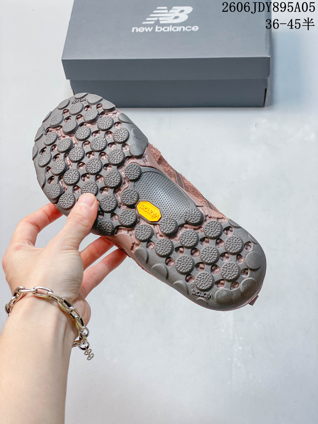 Close-up of the sneaker outsole with rounded tread elements and a yellow Vibram label