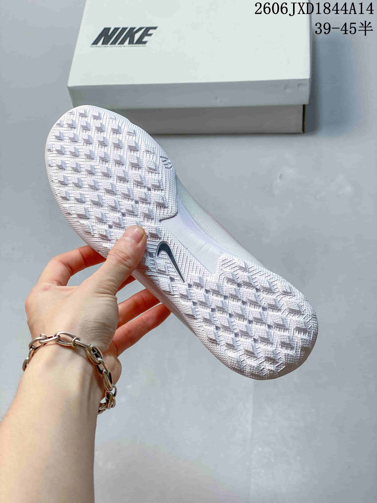 Close-up of the white studded outsole on a Nike soccer cleat.