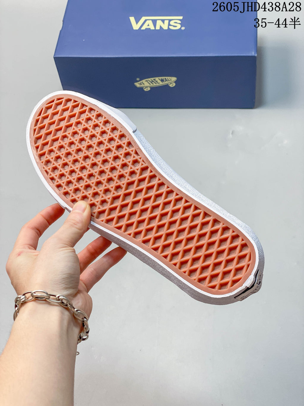 Close-up of the patterned rubber outsole and Vans shoebox
