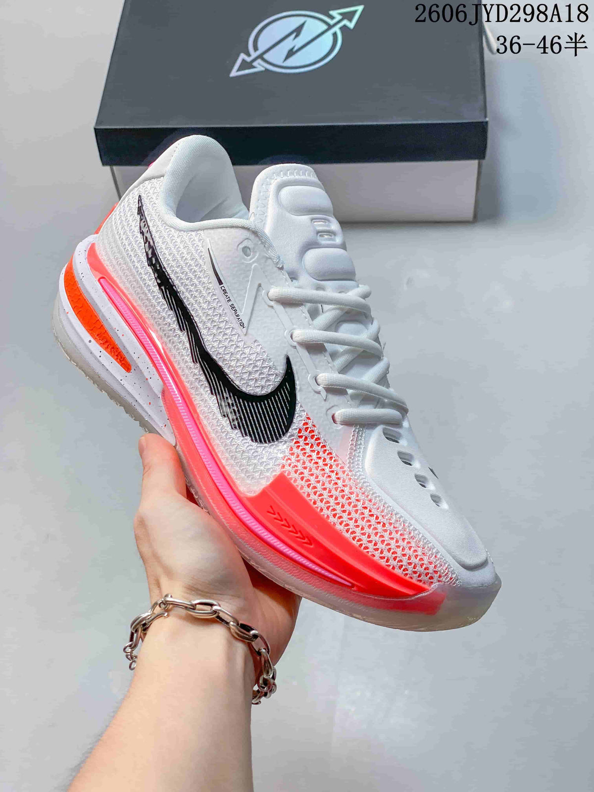 Angled side view highlighting the textured white upper, black Swoosh and bright coral details